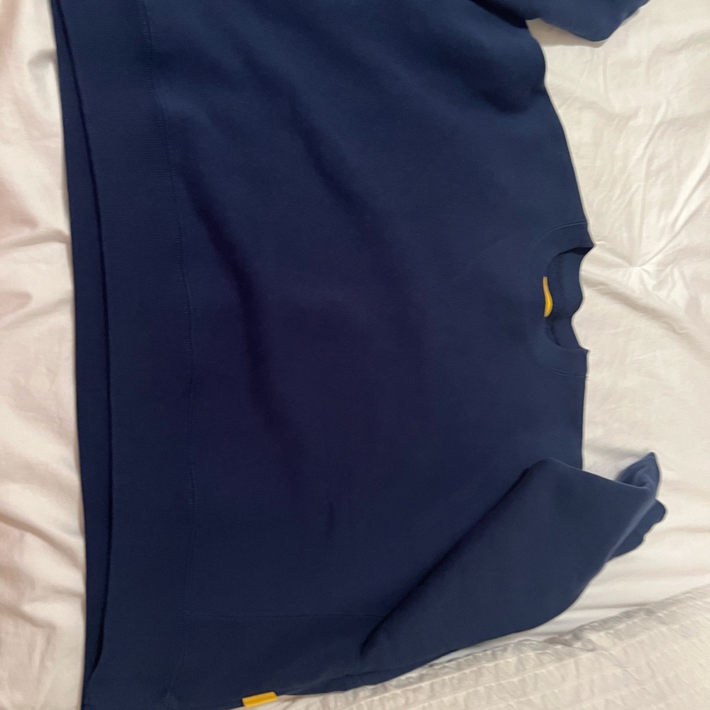 The yellow label blue sweatshirt
